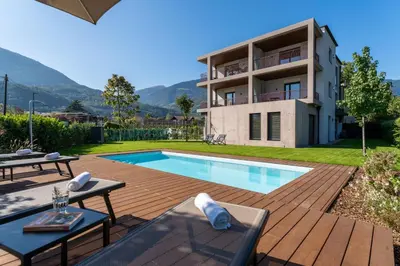 a villa with a swimming pool and a house at Apartments Villa Julia in Lana