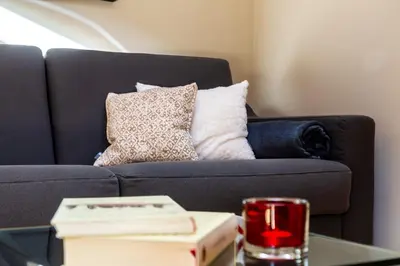 a living room with a couch and a table with a book at Residence Engel in Nova Levante