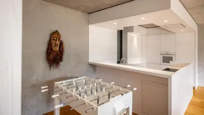 a kitchen with white cabinets and a wall at Olivia in Tirolo