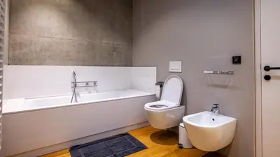 a bathroom with a tub and a toilet and a sink at Olivia in Tirolo