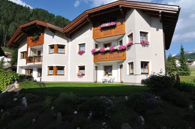 a large white building with flowers on the balconies at Apartment Suliva in Santa Cristina in Val Gardena