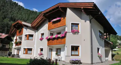 a building with flowers on the windows at Apartment Suliva in Santa Cristina in Val Gardena