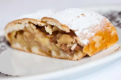 a pastry on a white plate on a table at Gasthof Tuscherhof in Braies
