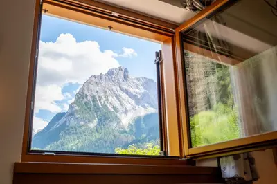 a view of a mountain through a window at Cesa Leo in Canazei