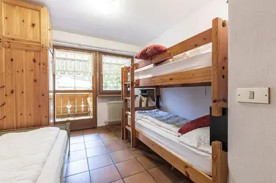 a bedroom with two bunk beds in a room at Cesa Testa in Canazei