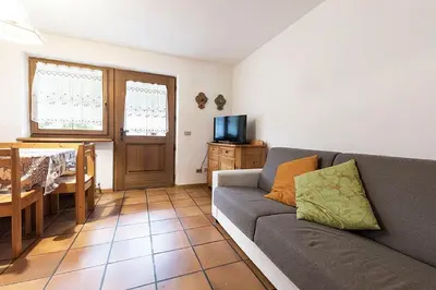 a living room with a couch and a table at Cesa Testa in Canazei