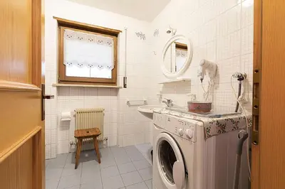 a washing machine in a bathroom with a sink at Cesa Testa in Canazei