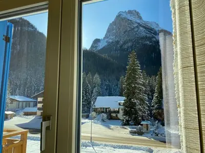 a window with a view of a snow covered mountain at Ciamorc Relax & Sport Appartament for max 2 Adults 1 child 1 infant in Canazei