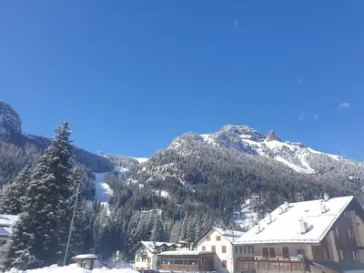 a ski resort with a mountain in the background at Ciamorc Relax & Sport Appartament for max 2 Adults 1 child 1 infant in Canazei