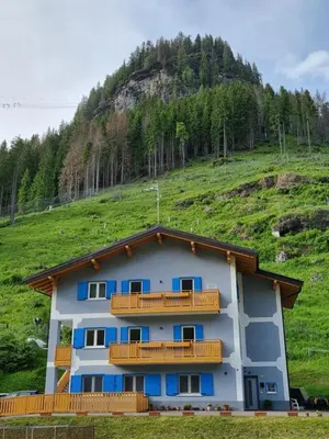 a building with balconies on the side of a hill at Ciamorc Relax & Sport Appartament for max 2 Adults 1 child 1 infant in Canazei