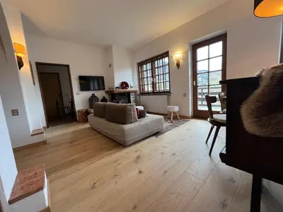 a living room with a couch and a table at Casalta by Go New Location in Moena