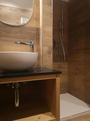 a bathroom with a sink and a shower at Casalta by Go New Location in Moena