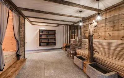 a wine tasting room with wooden walls and benches at Waldheim Appartements in Bressanone