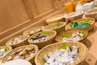 a table topped with baskets filled with candies at Waldheim Appartements in Bressanone