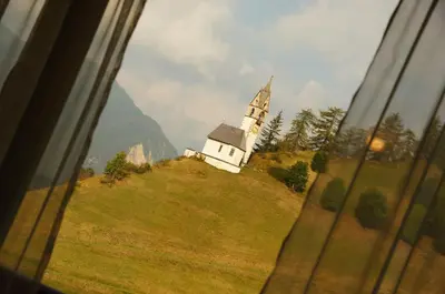 a church on top of a hill with a window at Miribunghof in La Valle