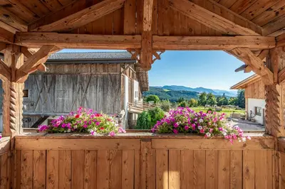 a wooden pergola with flowers on a balcony at Plattner-Hof in Petersberg