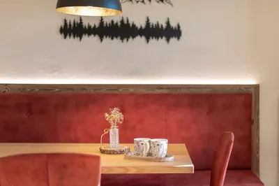 a dining room table with two mugs on it at Plattner-Hof in Petersberg