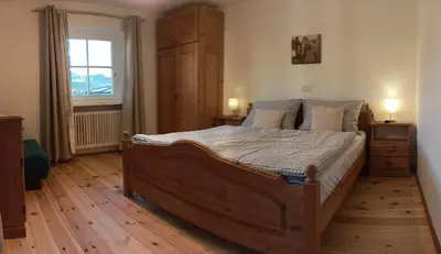 a bedroom with a large wooden bed and a window at Rasterhof in Aldino