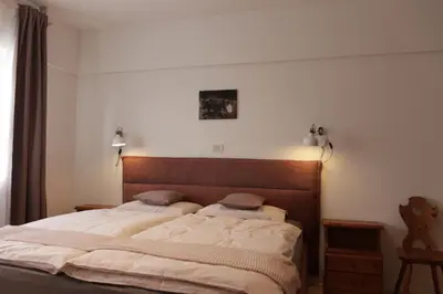 a bedroom with a large bed with two pillows at Rasterhof in Aldino