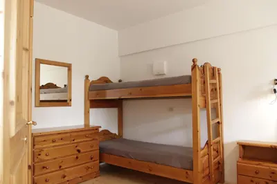 a bedroom with two bunk beds and a mirror at Rasterhof in Aldino