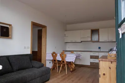 a living room with a couch and a table and chairs at Rasterhof in Aldino