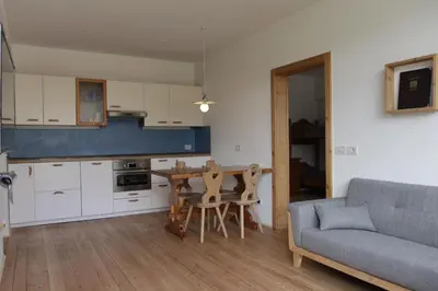 a kitchen and living room with a table and a couch at Rasterhof in Aldino