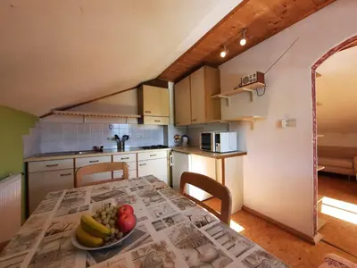 a kitchen with a table with a bowl of fruit on it at Wiesenheimhof - Apt 1 in Terento