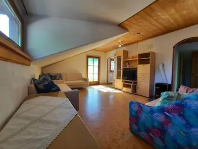 a large living room with a couch and a tv at Wiesenheimhof - Apt 1 in Terento