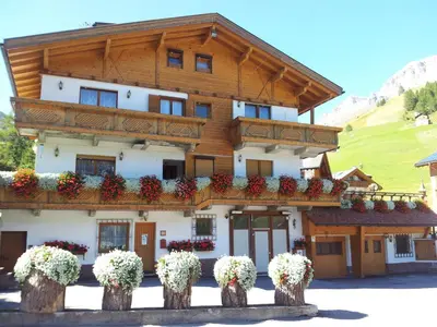a building with flowers in front of it at Chalet Belvedere in Arabba