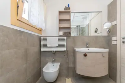 a bathroom with a toilet and a sink at Casa Carducci in Alleghe