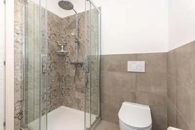 a bathroom with a shower and a toilet at Casa Carducci in Alleghe