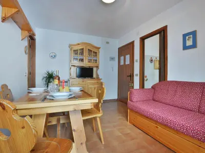 a kitchen with a table and chairs and a dining room at Apartment Des Alpes-3 by Interhome in Canazei