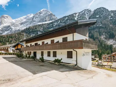 a mountain covered in snow with trees in the foreground at Apartment Penia 2-1 by Interhome in Penia