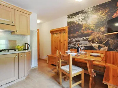 a bedroom with a bed with a colorful quilt at Apartment Penia 2-1 by Interhome in Penia
