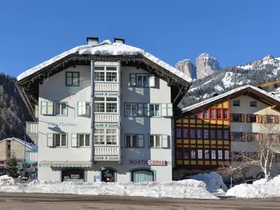 a white building with a snow covered roof at Apartment Villa Placidia Apt 32 by Interhome in Campitello di Fassa