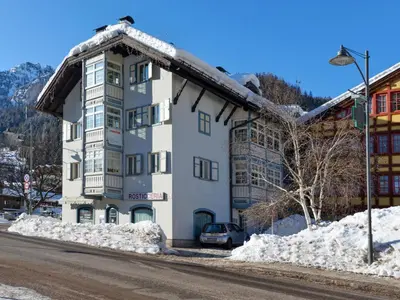 a white building with snow on the side of a street at Apartment Villa Placidia Apt 34 by Interhome in Campitello di Fassa