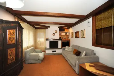 a living room with two couches and a tv at APPARTAMENTO FIEMME in Predazzo