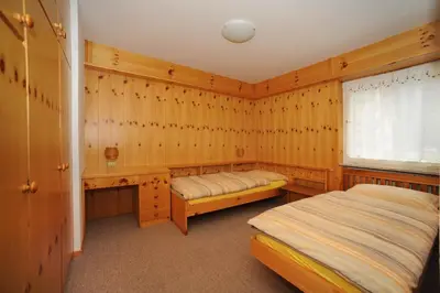 a bathroom with a toilet sink and a washing machine at APPARTAMENTO FIEMME in Predazzo