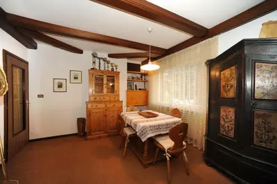 a kitchen with a table with a pink table cloth at APPARTAMENTO FIEMME in Predazzo