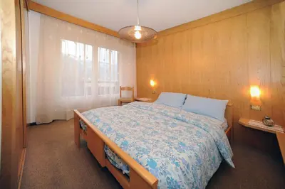 a bedroom with two beds and a window at APPARTAMENTO FIEMME in Predazzo