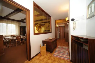 a bedroom with a large bed and a window at APPARTAMENTO FIEMME in Predazzo