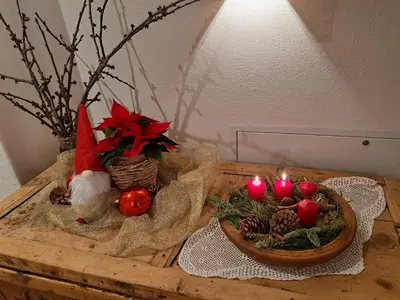 a table with a santa hat and candles on it at Pignathof Rosacea in Campodazzo
