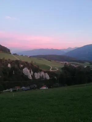 a view of a field with mountains in the background at Wiesenheimhof - Apt 2 in Terento