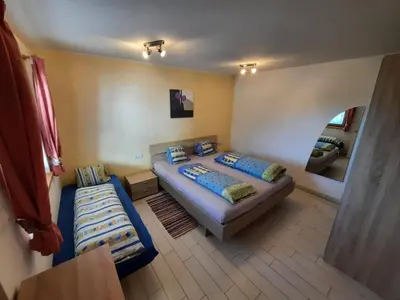 a small bedroom with two beds and a mirror at Wiesenheimhof - Apt 2 in Terento