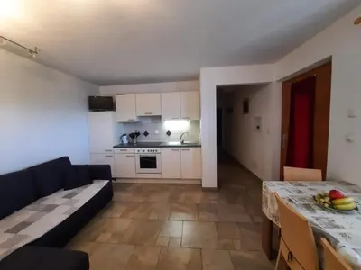a living room with a couch and a kitchen at Wiesenheimhof - Apt 2 in Terento