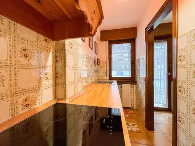 a kitchen with a counter top in a room at Appartamenti Des Alpes in Canazei