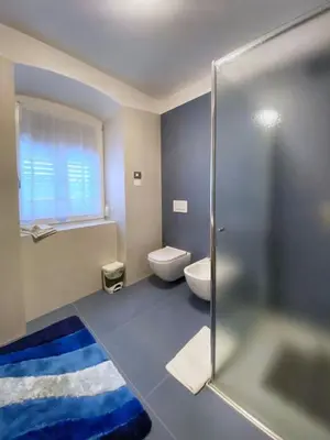 a bathroom with a toilet and a sink and a shower at Casa vacanze Da Bianca in Castelfondo