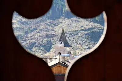 a view of a church seen through a window at Apartments Anny in Canazei
