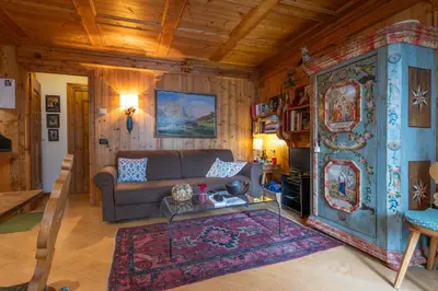 a living room with a couch and a table at Casa Lacedel 1, on ski slopes in Cortina dʼAmpezzo