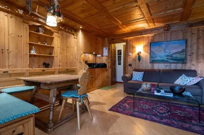 a living room with a couch and a table at Casa Lacedel 1, on ski slopes in Cortina dʼAmpezzo